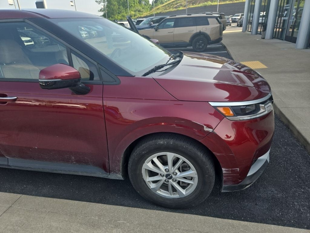 2024 Kia Carnival LX in Flare Red — front three-quarter view